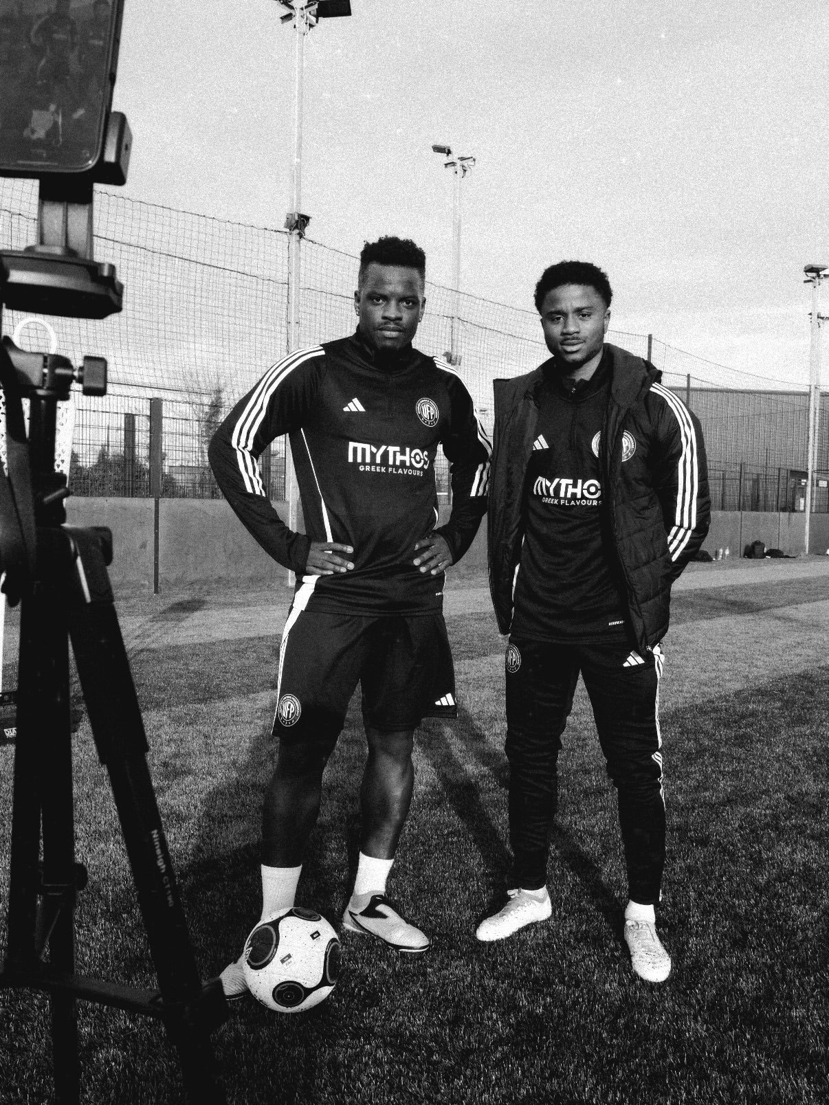Coach working with a player on the pitch